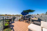 Enjoy breathtaking views from this stunning rooftop terrace! This outdoor oasis features a stylish seating area, perfect for entertaining or relaxing.