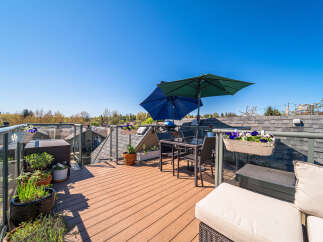 Enjoy breathtaking views from this stunning rooftop terrace! This outdoor oasis features a stylish seating area, perfect for entertaining or relaxing.