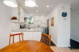 This stunning kitchen boasts a modern design with sleek white cabinetry and a beautiful countertop.