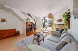Step into this inviting living space, featuring a cozy fireplace and a stylish, modern design.