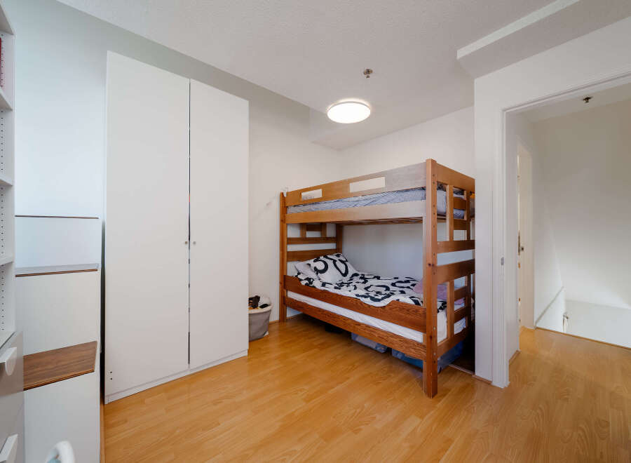 This cozy bedroom features a charming bunk bed, perfect for kids or guests.