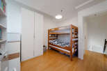 This cozy bedroom features a charming bunk bed, perfect for kids or guests.