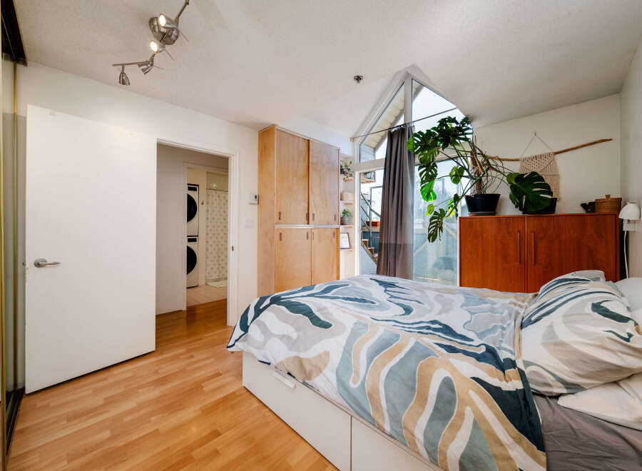 Discover this stylish bedroom featuring a modern design and ample natural light.