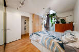 Discover this stylish bedroom featuring a modern design and ample natural light.