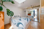 This bright and airy bedroom features a modern design with a large bed and ample natural light.