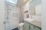 This modern bathroom features a sleek design with white subway tiles and a contemporary vanity.