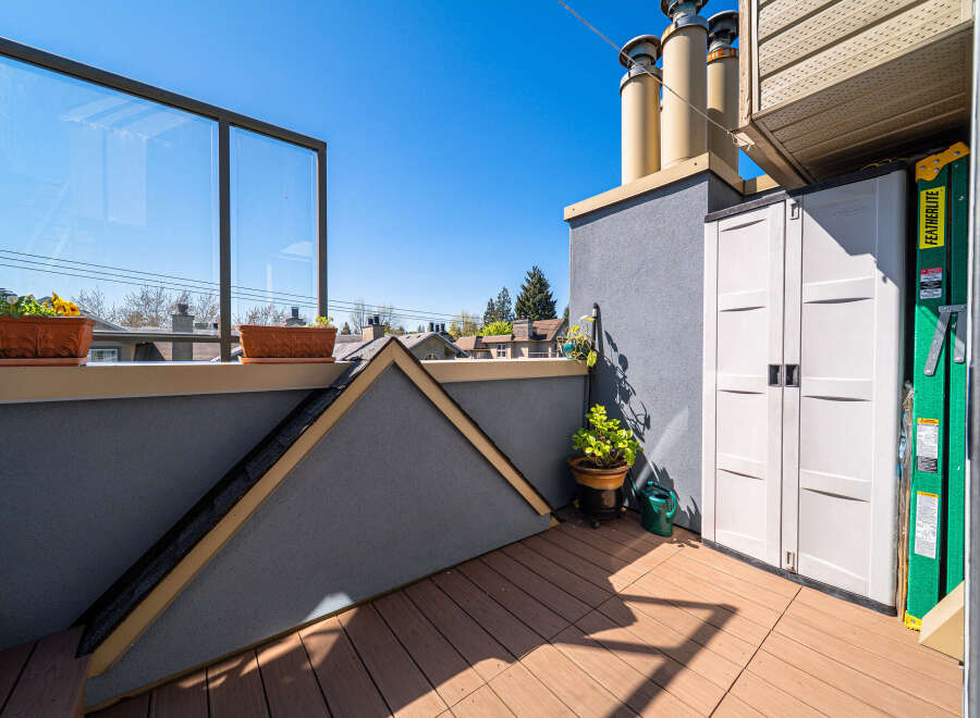 Enjoy the outdoors from this beautiful rooftop deck! This space features a modern design with a glass railing, perfect for taking in the views.