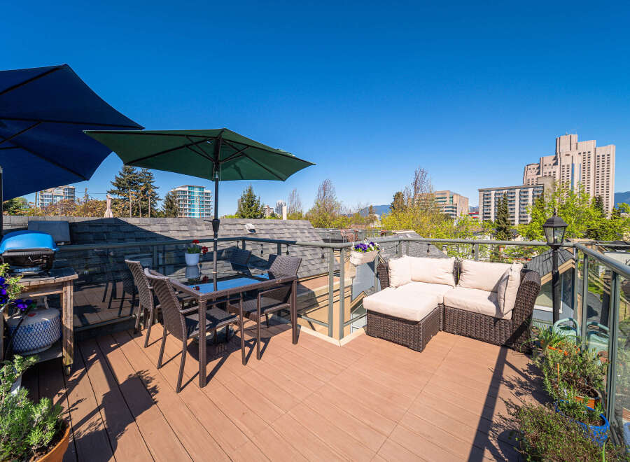 Enjoy breathtaking views from this stunning rooftop patio! This outdoor space features a comfortable seating area, perfect for relaxing or entertaining.