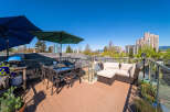 Enjoy breathtaking views from this stunning rooftop patio! This outdoor space features a comfortable seating area, perfect for relaxing or entertaining.