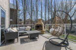 Enjoy outdoor living at its finest with this stunning patio space! Featuring a cozy seating area, a stylish coffee table, and a unique hanging chair, perfect for relaxation.