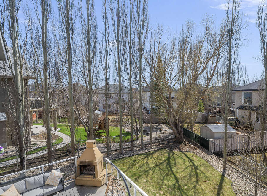 Enjoy outdoor living at its finest with this stunning property featuring a spacious backyard and a cozy fireplace.
