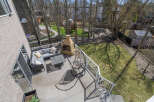 Enjoy outdoor living at its finest with this stunning property featuring a spacious deck and a cozy fireplace.