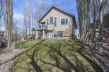 This stunning property boasts a beautiful exterior with a well-maintained lawn and mature trees.