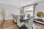 Step into luxury with this stunning dining room! Featuring a dark wood dining table and elegant white chairs, this space is perfect for hosting dinner parties.