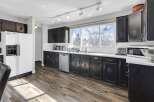 This stunning kitchen boasts dark cabinetry, offering a sophisticated and timeless aesthetic.