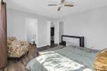 Step into this inviting bedroom, featuring a comfortable bed and a stylish armchair.