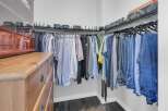 Step into a well-organized walk-in closet, perfect for maximizing storage space.