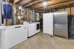 Discover the convenience of this property's well-equipped laundry area, featuring a washer, dryer, and additional freezer space.