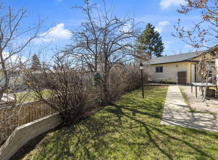 Discover this charming property featuring a well-maintained yard and a welcoming pathway.