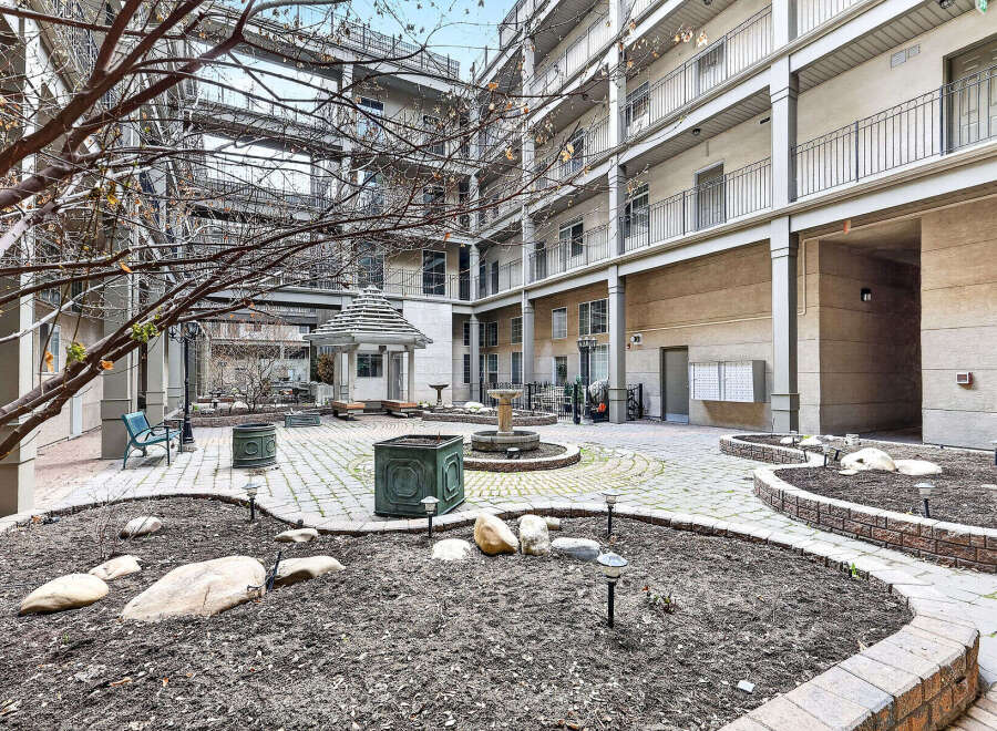 Discover a serene oasis in this stunning property, featuring a beautifully landscaped courtyard.