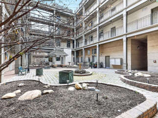 Discover a serene oasis in this stunning property, featuring a beautifully landscaped courtyard.