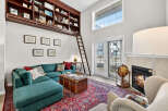 Step into luxury with this stunning property featuring a cozy fireplace and a unique built-in bookshelf.