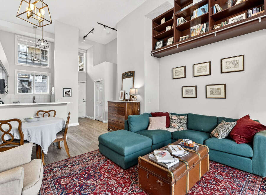 This stunning property boasts a spacious living area with a cozy sectional sofa and a stylish trunk coffee table.