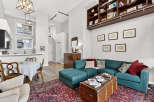 This stunning property boasts a spacious living area with a cozy sectional sofa and a stylish trunk coffee table.