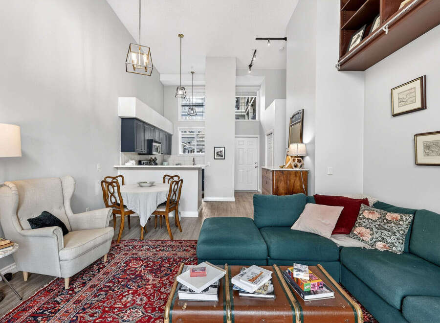 Discover the charm of this stunning property, featuring a spacious living area with high ceilings and an open-concept kitchen.