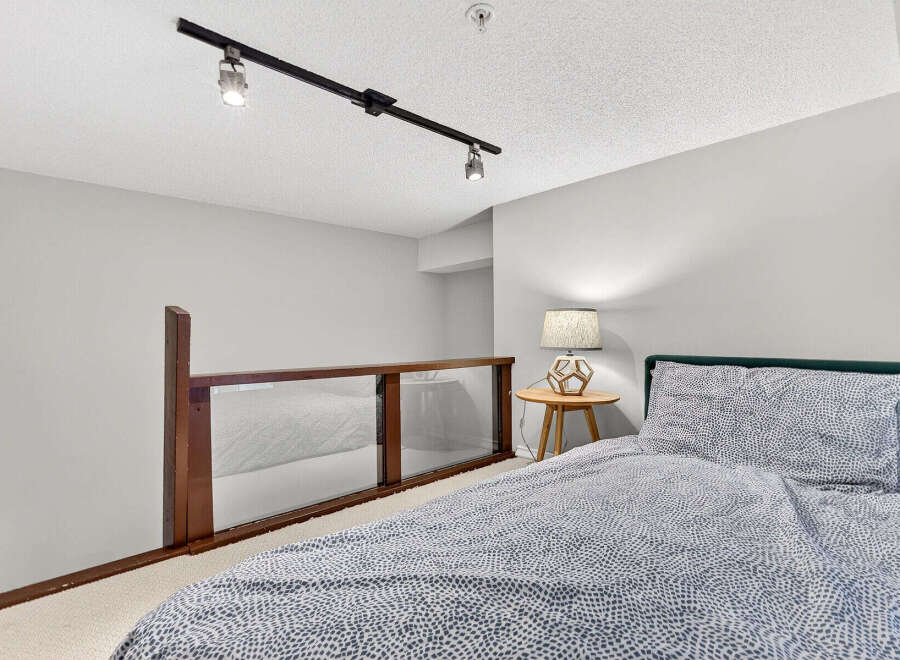 Discover the charm of this inviting bedroom, featuring a cozy bed adorned with stylish bedding.