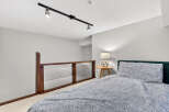Discover the charm of this inviting bedroom, featuring a cozy bed adorned with stylish bedding.