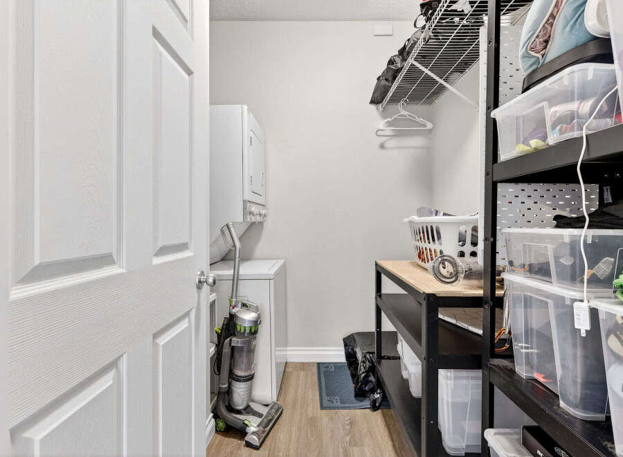 Discover the convenience of this well-organized laundry room, featuring a modern washer and dryer setup.