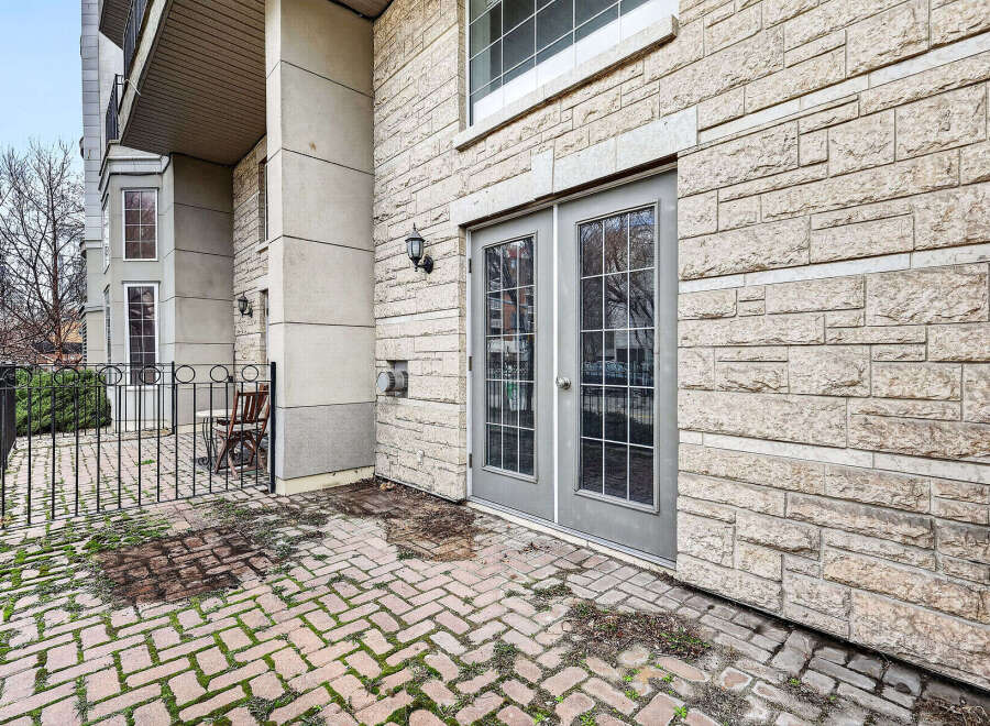 Discover this stunning property featuring a beautiful brick patio and elegant double doors.