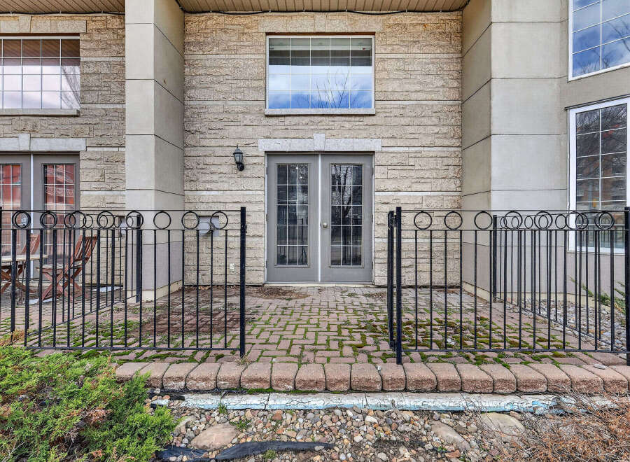 Discover this charming property featuring a welcoming patio with a stylish wrought iron fence.