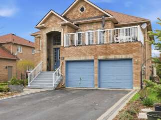 This stunning brick home boasts a charming facade and a welcoming entrance.
