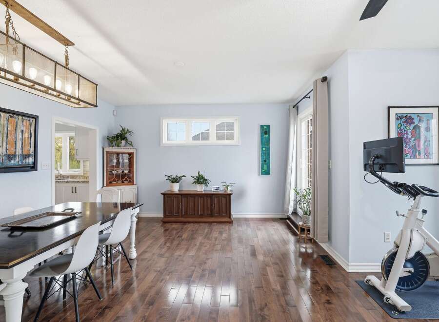 Step into this inviting living space, featuring a stunning dining area with a modern table and stylish chairs.