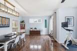 Step into this inviting living space, featuring a stunning dining area with a modern table and stylish chairs.