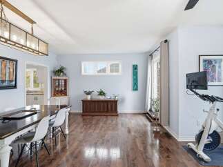 Step into this inviting living space, featuring a stunning dining area with a modern table and stylish chairs.