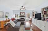 This stunning living room boasts a cozy fireplace, perfect for chilly evenings, and a sleek entertainment center.