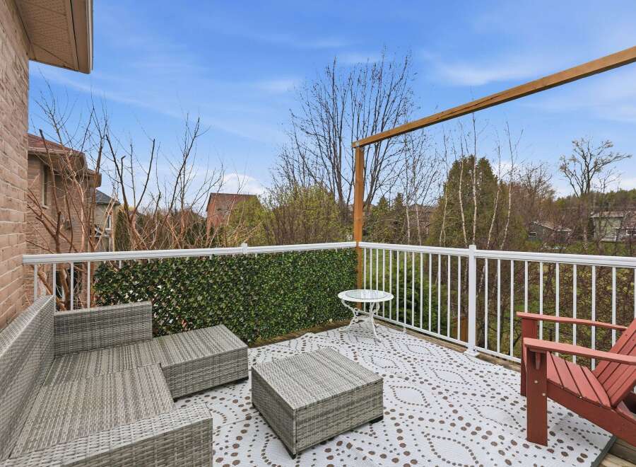 Enjoy outdoor living at its finest on this beautiful deck! This space features comfortable seating, a stylish coffee table, and a charming accent wall.
