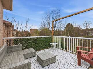 Enjoy outdoor living at its finest on this beautiful deck! This space features comfortable seating, a stylish coffee table, and a charming accent wall.