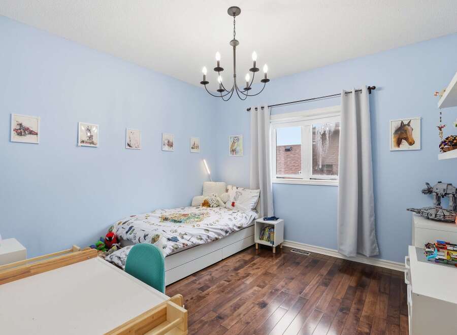 This charming bedroom features a cozy bed, perfect for a child's retreat.