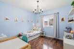 This charming bedroom features a cozy bed, perfect for a child's retreat.