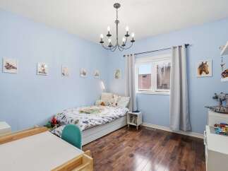 This charming bedroom features a cozy bed, perfect for a child's retreat.