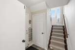 Step into this inviting entryway, featuring a staircase leading to the upper levels.