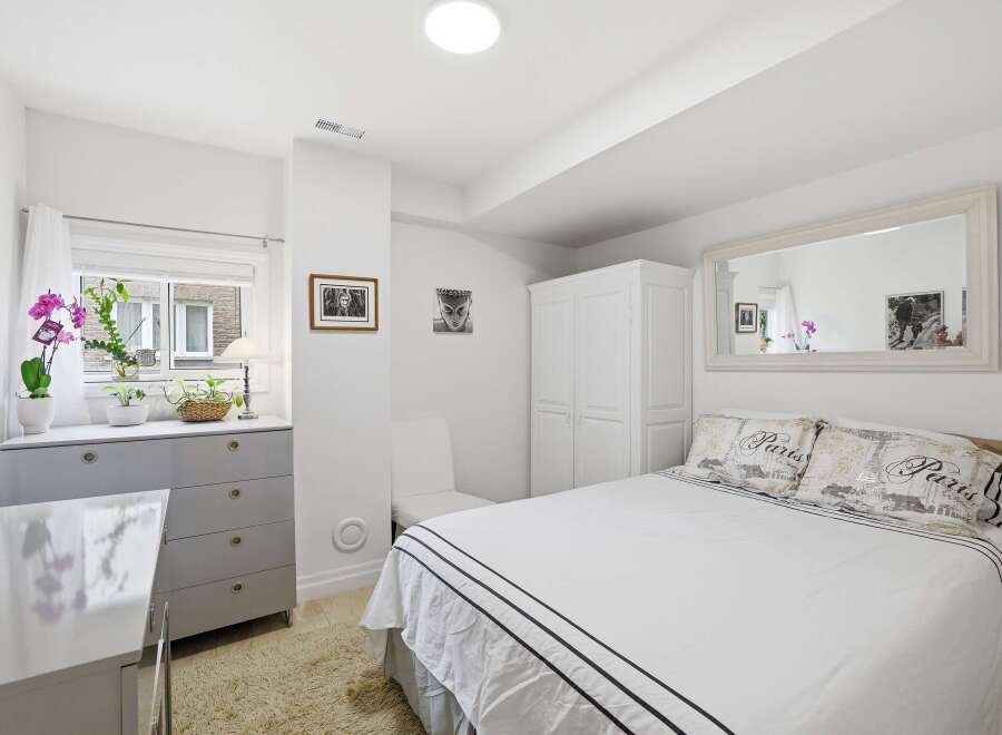 This bright and airy bedroom offers a serene retreat.