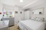 This bright and airy bedroom offers a serene retreat.