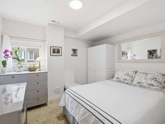 This bright and airy bedroom offers a serene retreat.