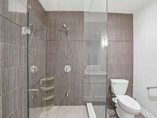 Step into a modern bathroom oasis! This stunning space features a sleek glass shower enclosure, perfect for a spa-like experience.