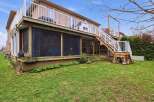 Enjoy outdoor living at its finest with this stunning property featuring a multi-level deck and screened-in porch.